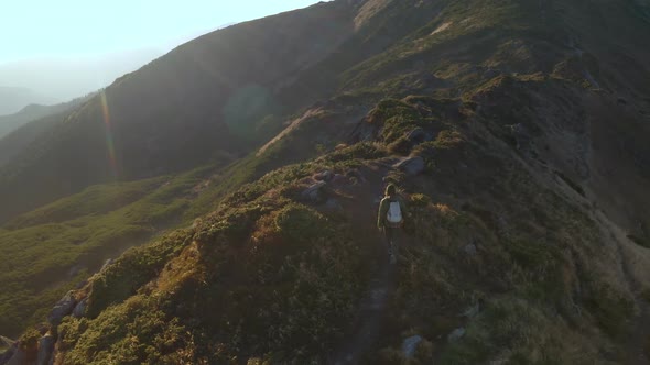 Aerial View of Hiker Man with Backpack on Top of a Mountain