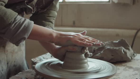 Female Potter Wheel Throwing in Workshop