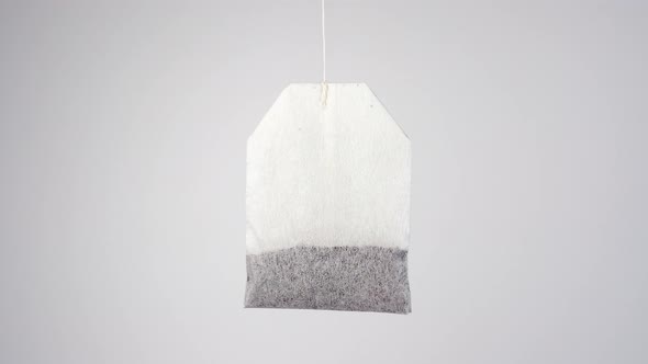 Herbal tea bag hanging on a thread 