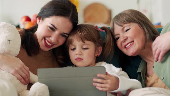 Laughing family watching something on the tablet