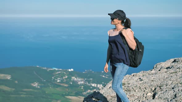 Active Happy Caucasian Female Tourist Having Fun and Enjoying Standing on High Cliff