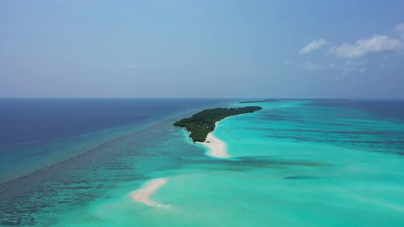 Natural overhead copy space shot of a white sandy paradise beach and aqua blue ocean background in h