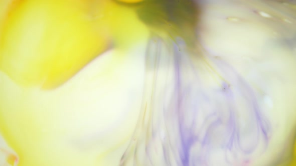 Ink in Water. Yellow and Violet Ink Reacting in Water Creating Abstract Background. alt