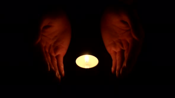 Hands Holding a Burning Candle in Dark 001 alt