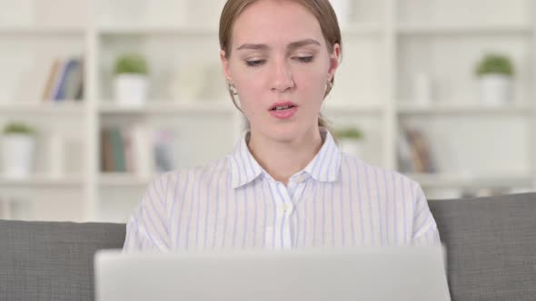 Portrait of Young Woman with Laptop Having Headache