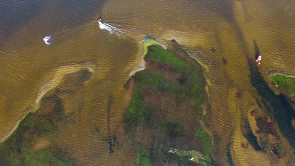 Aerial view of person kitesurfing on caiupe Lagoon in Brazil.