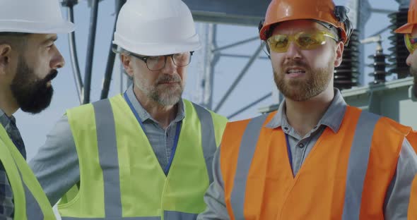 Foreman Speaking with Colleagues on Power Station