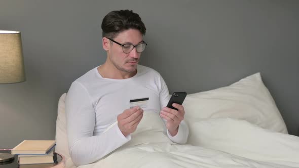 Online Payment Success on Smartphone By Middle Aged Man in Bed