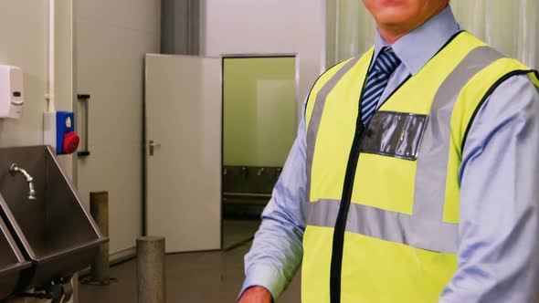 Portrait of inspection officer standing with arms crossed