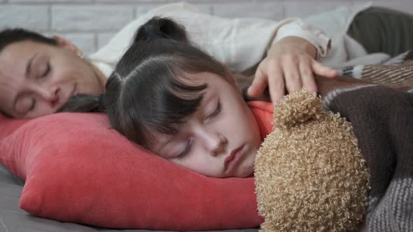 Sleeping Girl with Toy By Mother