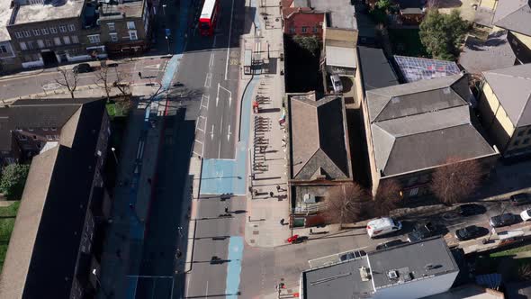 Pan up reveal aerial drone shot of city of London buildings from Whitechapel road