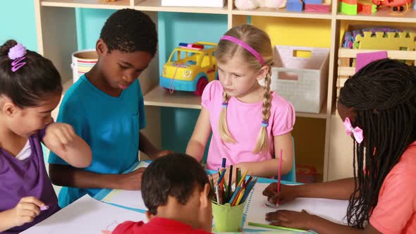 Preschool Class Drawing at Table in Classroom