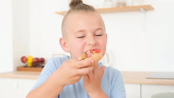 Young Family Deliciously Eating Italian Pizza Sitting in the Kitchen at the Table