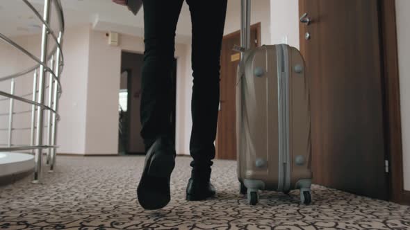 Businessman with His Suitcase at the Hotel Room