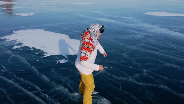 Aerial View of Man Skating on Lake Baikal Covered By Ice