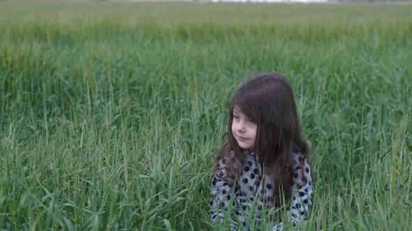 A child in a field outside the city.