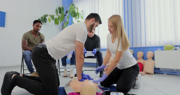 Stay Away Moment During the Defibrillation Process on a First Aid Group Training Indoors