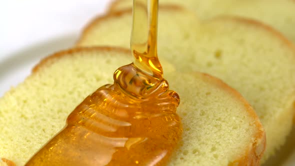 Honey pouring on bread, Slow Motion