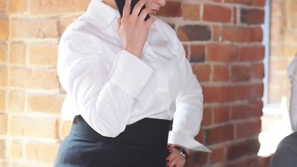 Blonde Short Hair Business Lady Talking on Smartphone in a Modern Office.