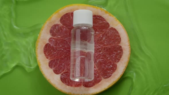 Water Flowing Slow Mo Around Moisturizing Gel Lotion Lying on Grapefruit Slice