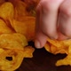 Hand Takes Golden Potato Chips From the Pack - VideoHive Item for Sale