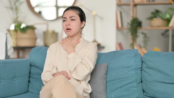 Sick Indian Woman Coughing on Sofa 