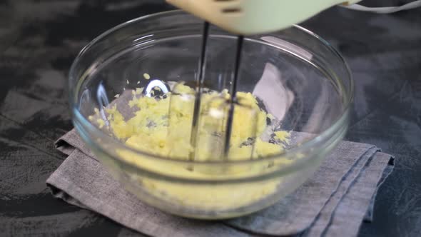 Mixing butter with sugar with the hand mixer