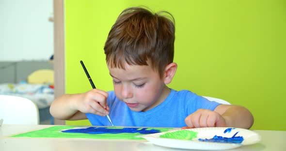 Happy Cute Children a Girl of 7-8 Years Old and Preschool Boy Paint at Home with Watercolors Sitting