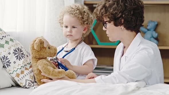 Little Blond Boy Playing Doctor with Mother