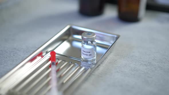 High Angle View Covid19 Vaccine on Metal Tray with Sterile Syringe Closeup