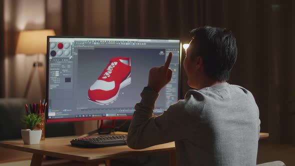 Male Footwear Designer Thinking Then Raising Index Finger While Designing Shoe On A Desktop At Home