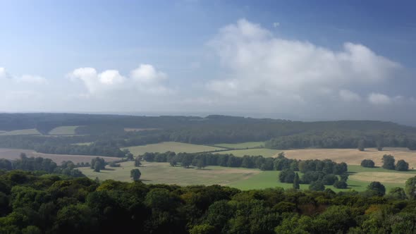 Aerial view panning left over Buckinghamshire countryside in England