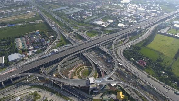 Aerial View of Highway Road Interchange with Busy Urban Traffic Speeding on Road