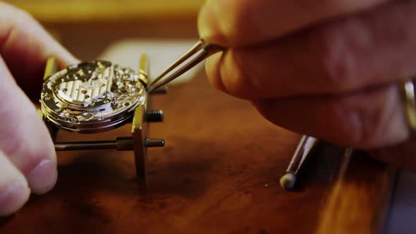 Close-up of horologist hands repairing a watch