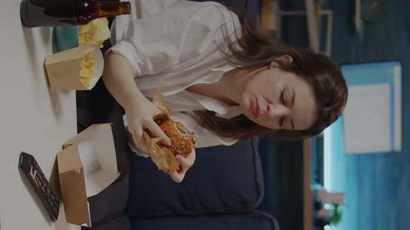 Vertical Video Caucasian Woman Eating Hamburger From Delivery Bag