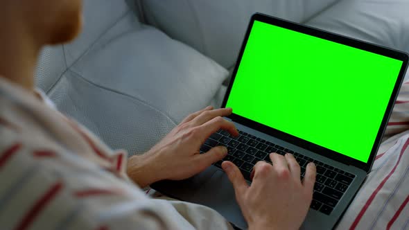 Man Surfing Chroma Key Laptop at Home Office