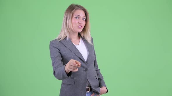 Happy Young Beautiful Blonde Businesswoman Pointing at Camera