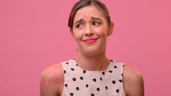 Female Mocks Showing Hand Blah Blah Blah Gesture on a Pink Background.