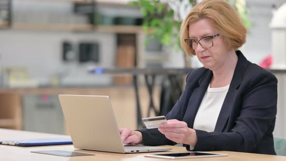Old Businesswoman Having Online Payment Failure on Laptop in Office 