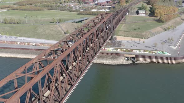 Commuter Train Passing Fast Over an Old Iron Bridge