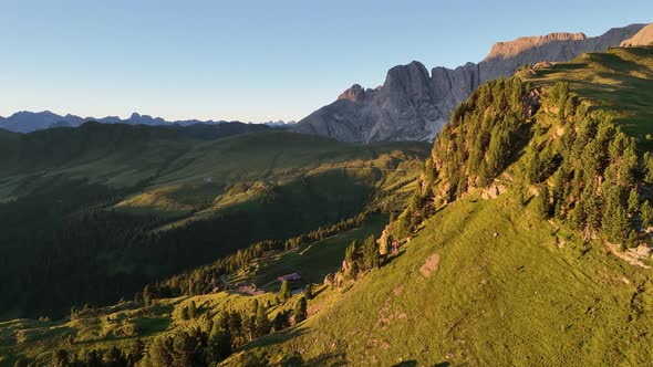 Dolomites mountains peaks with a hiking path on a summer sunrise