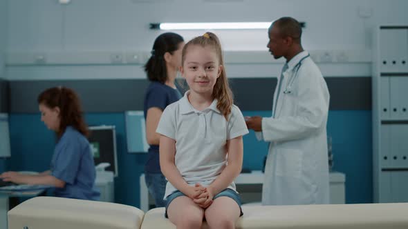 Portrait of Small Child Waiting to Receive Medical Advice From Doctor