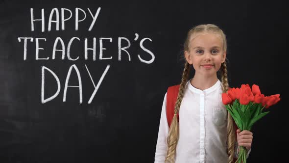 Happy Teachers Day Written on Blackboard, Schoolgirl Holding Bunch of Tulips