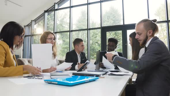 Group of Young Multi Ethnic Business People Meeting at Boardroom Table