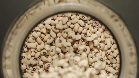 White Beans Pouring Into A Glass Jar