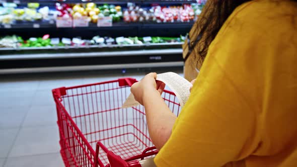 Woman Checks Paper Receipt Previous Purchase Compares Large Increase in Food Priceswoman in Shopping