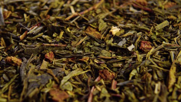 Dry green tea leaves with hemp and rose. Herbal wellness mix. Macro