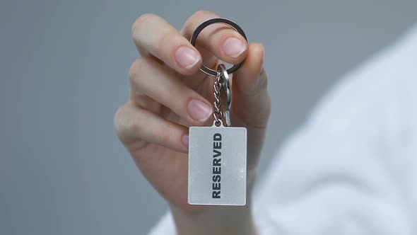 Female Hand Clenching Keychain With Reserved Word, Luxury Hotel Service, Trip