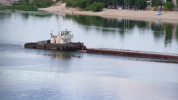 Tug Flowing Along River Daylight Drone Shot