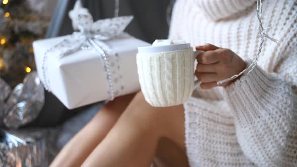 Girl Holding Hot Cocoa With Marshmallows And Gift Box Celebrating Christmas